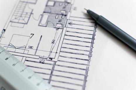 Image of architect plans with a pen and ruler