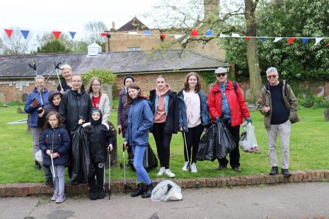 Photo of group of people with litter picking equipment